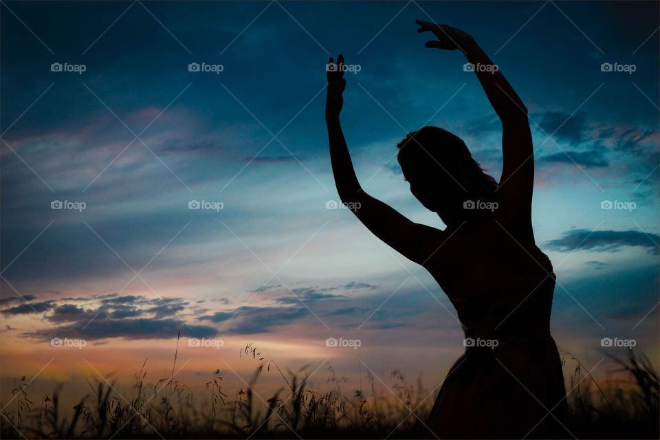 A ballerina's silhouette in a farmer' field 