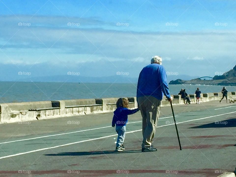 Grandad and grandson strolling 