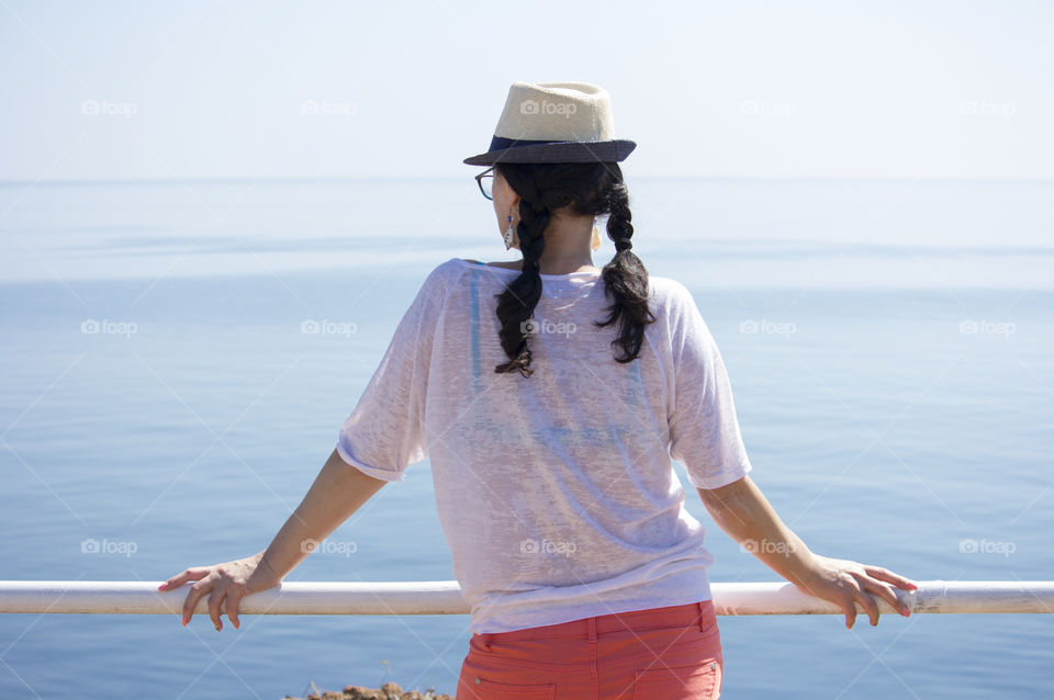 A woman from behind and the sea