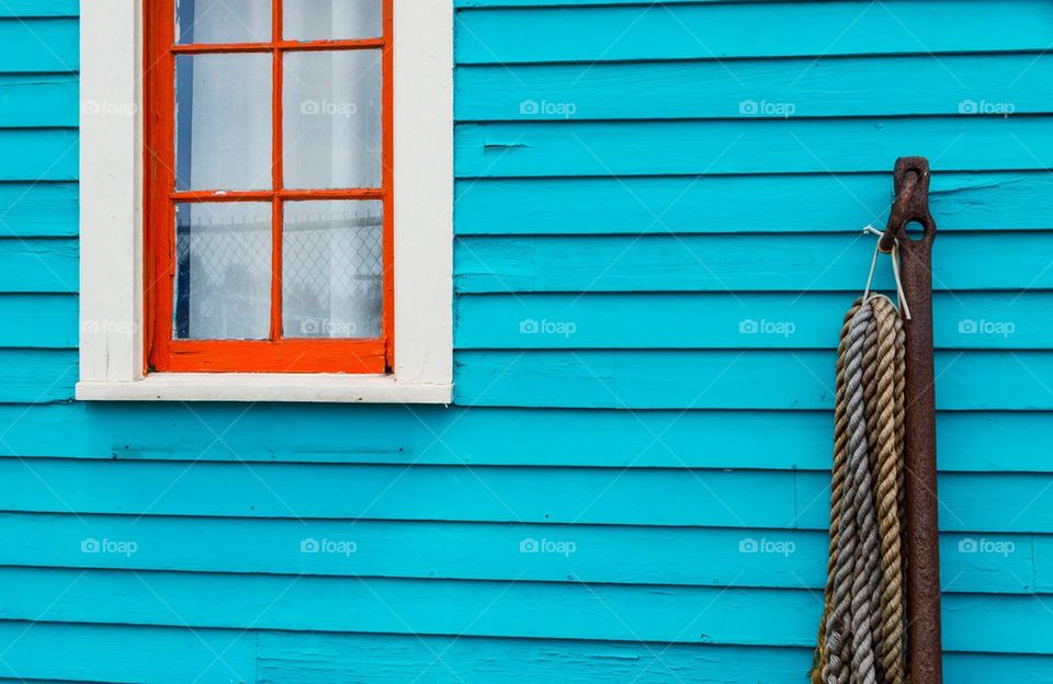 Brightly colored house with anchor and rope