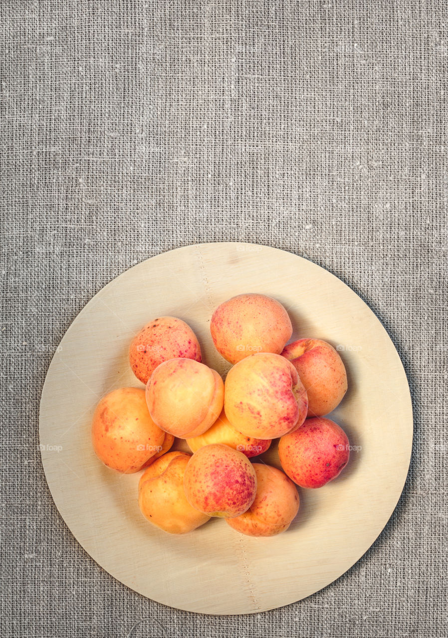 Apricots on wooden table. Fresh apricots straight from the garden on wooden plate