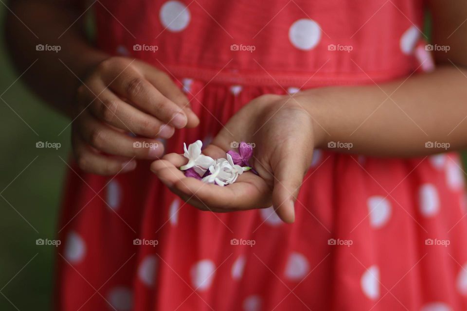 Girl in a red polka dots dress and flowers