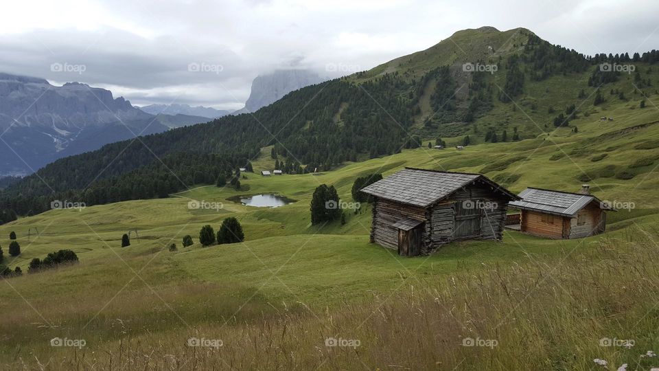 Beautiful view of green fields and mountains when hiking in Val Gardena Italy 
