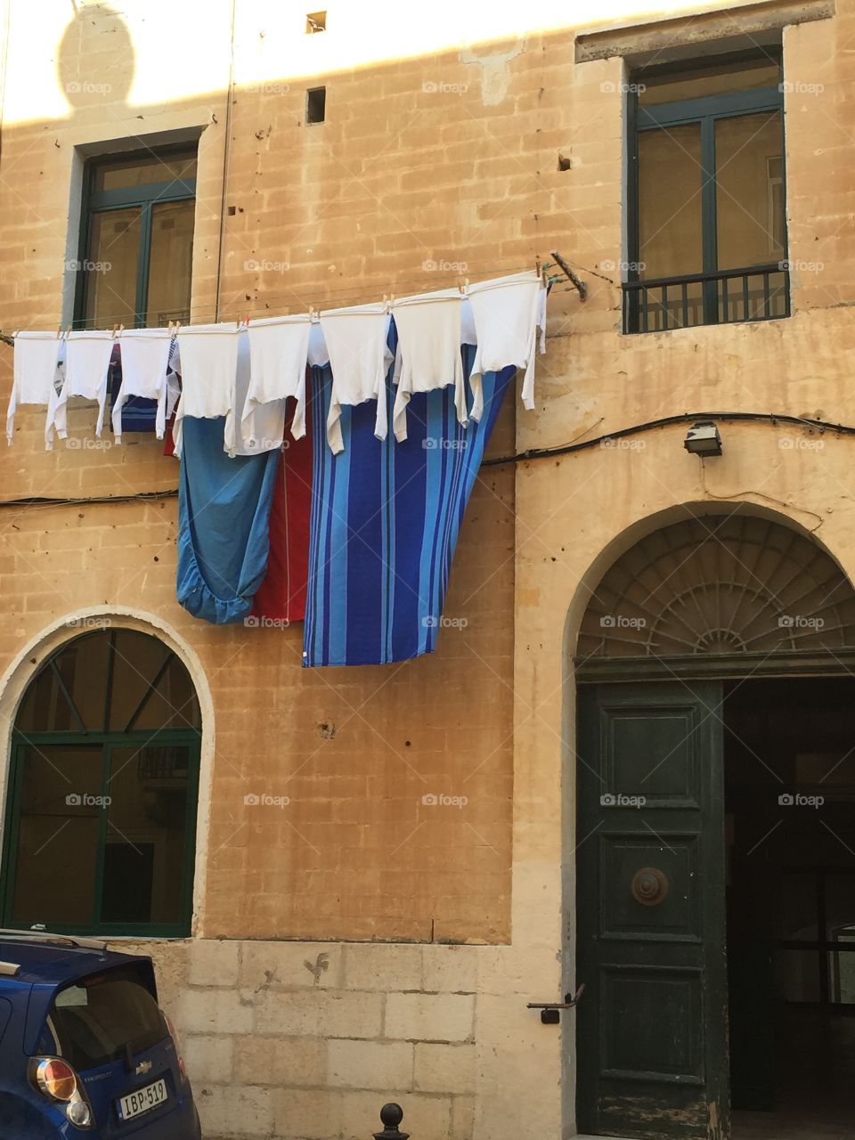 Windows around the World. Windows provide access to washing lines in the Capital City of Valletta, Malta. 
(Wash Day).