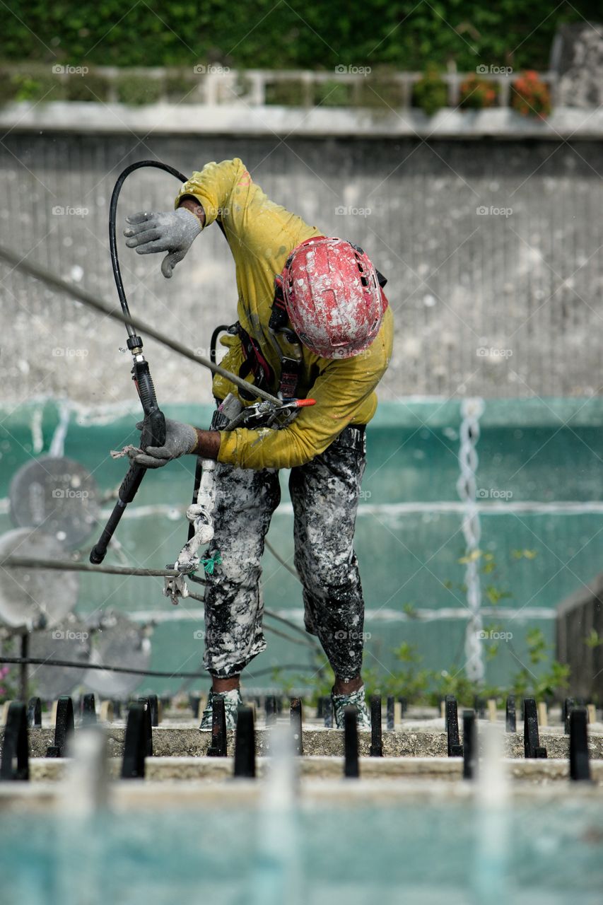 Worker abseiling down tower block in Kuala Lumpur Malaysia