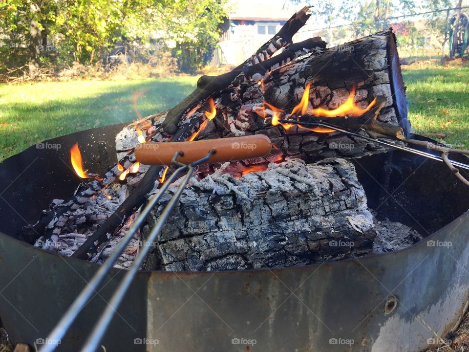 Roasting hotdogs over the campfire