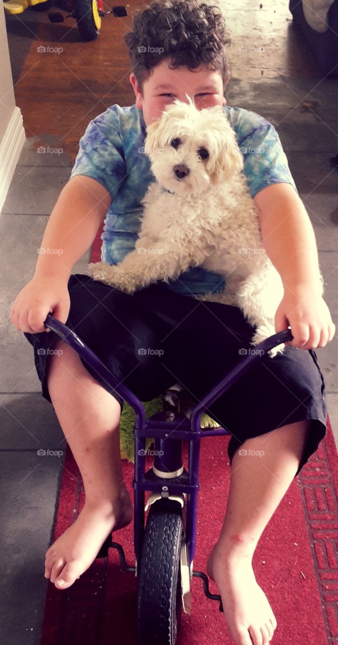 George the dog gets a ride on the trike. I'm not sure if he is happy about it but its happening anyway!. My son couldn't be happier about it. Best friends.