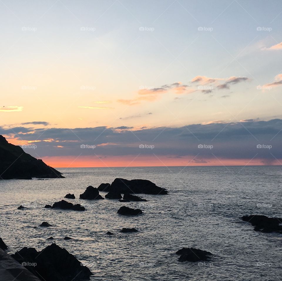 Sunset, seascape and peace in Ilfracombe. The pink skyline with the dark rocks all surrounded by our beautiful sea. 