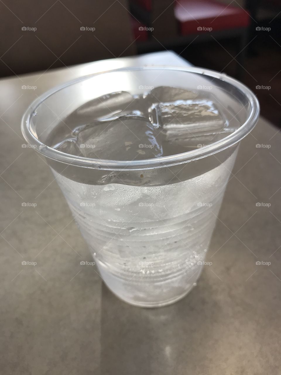 A cup of iced cold water that quenches my thirst. It is definitely a healthy drink to consume on a sizzling day.