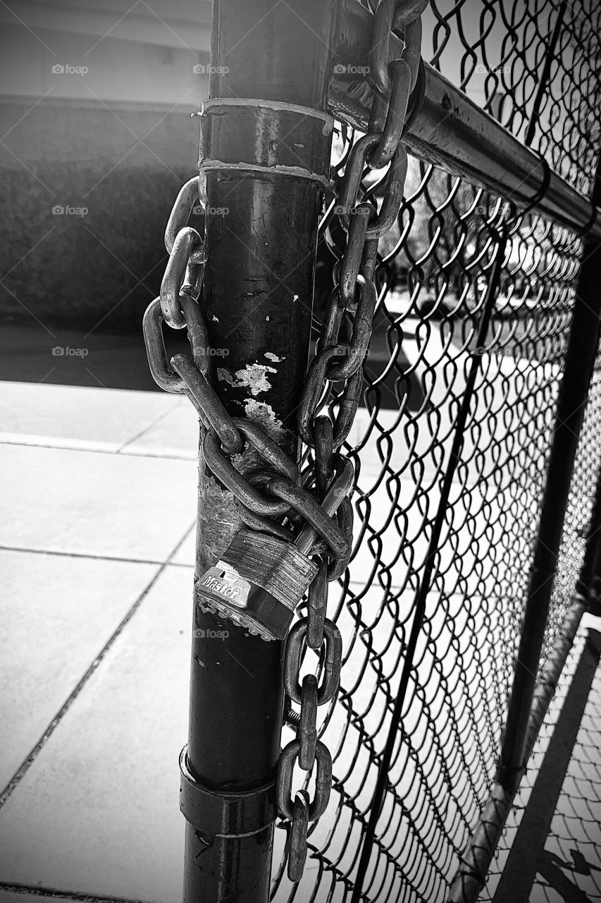Metal Lock on the gated fence outside at the park 
