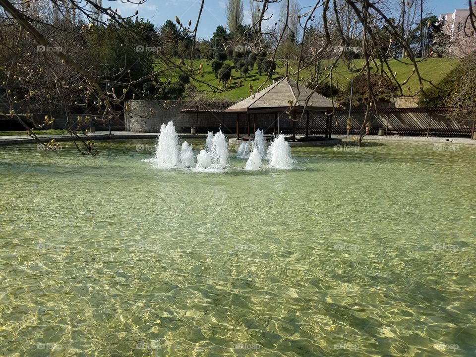 a small water fountain in a small park in Ankara