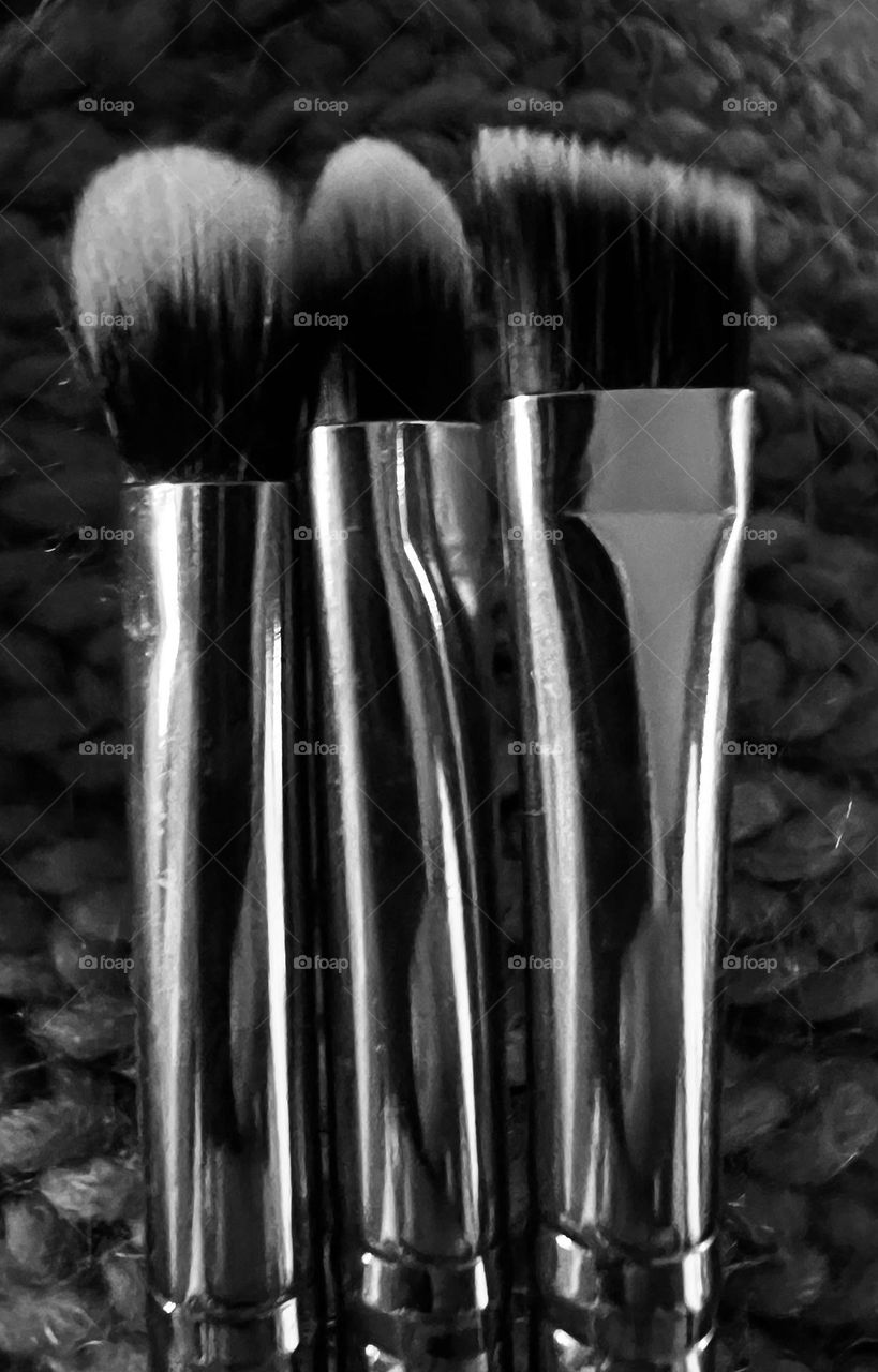 Black and white of makeup brushes that are shiny and new! Don’t really wear makeup lol 😂