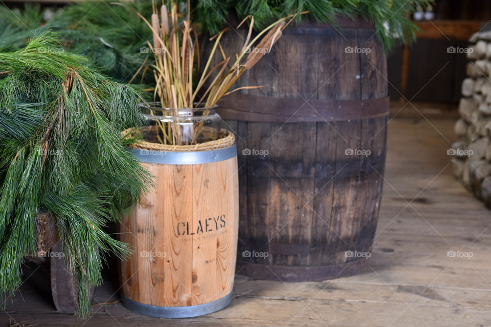 Christmas pine branches next to a vintage wooden barrel