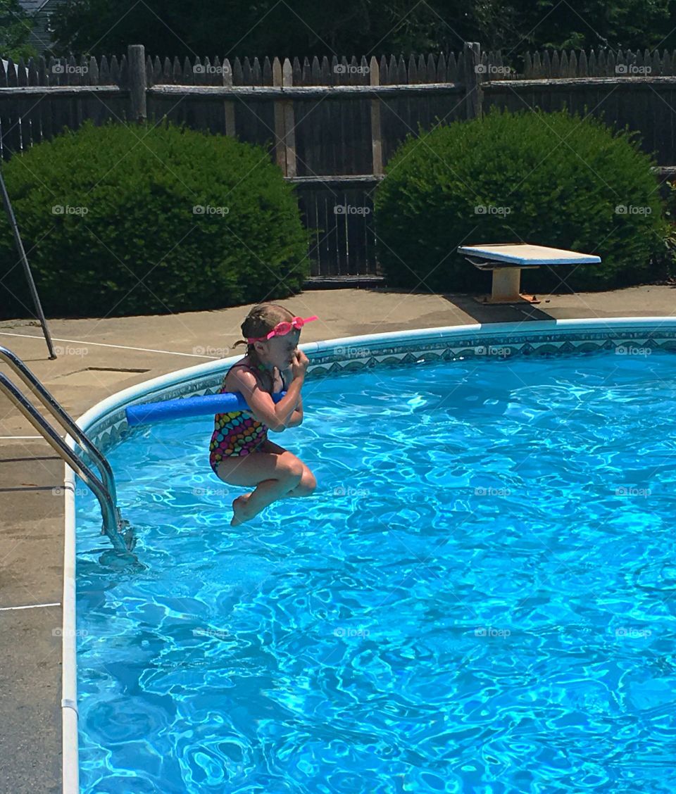 Go ahead and jump!  Cooling off on a hot summer day by jumping into the pool. Blue water, refreshing 