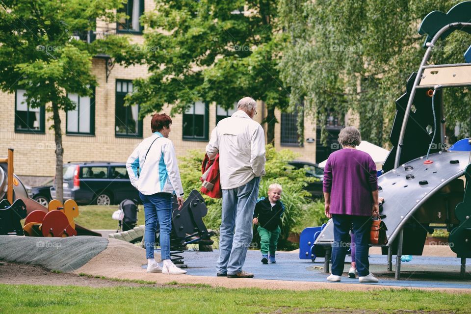 Grandparents at the playground with their grandkids