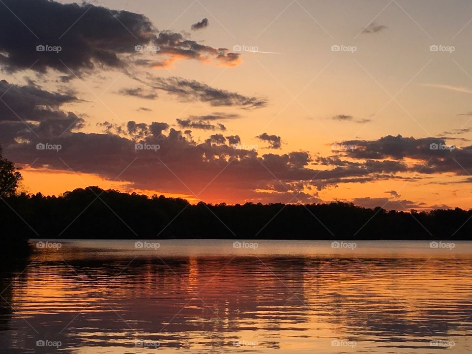 Sunset and clouds on lake