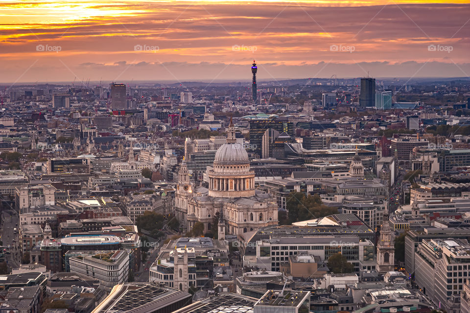 London. UK. Sunset over city district with visible dome of the St. Paul's Cathedral.