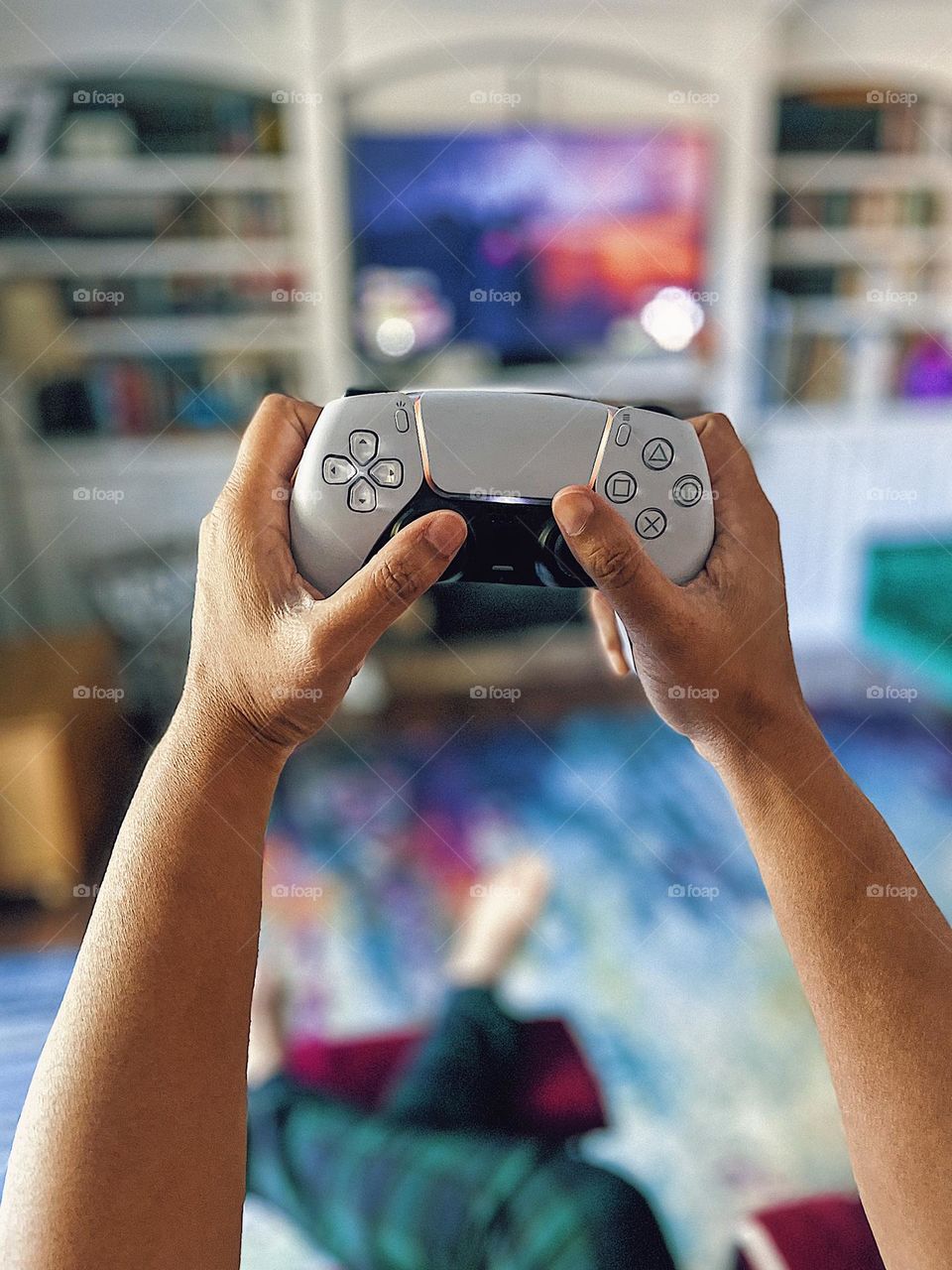 Woman playing Harry Potter game on PlayStation, woman holding PS5 controller, woman’s hands holding PS5 controller, gaming on a PlayStation console, PlayStation 5 gamers view