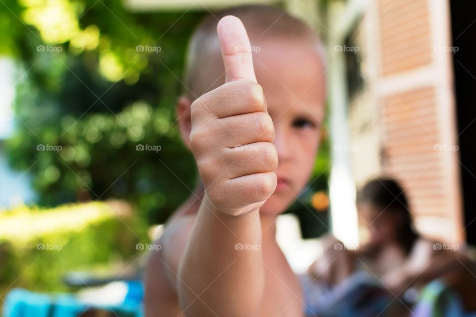 Boy showing thumb up