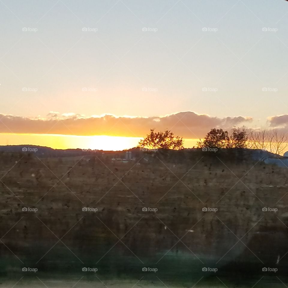 sun over a farmstead