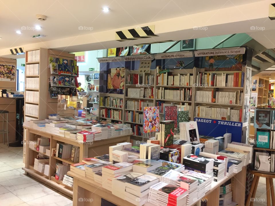 Books on shelves and table inside Kléber bookstore in Strasbourg France 