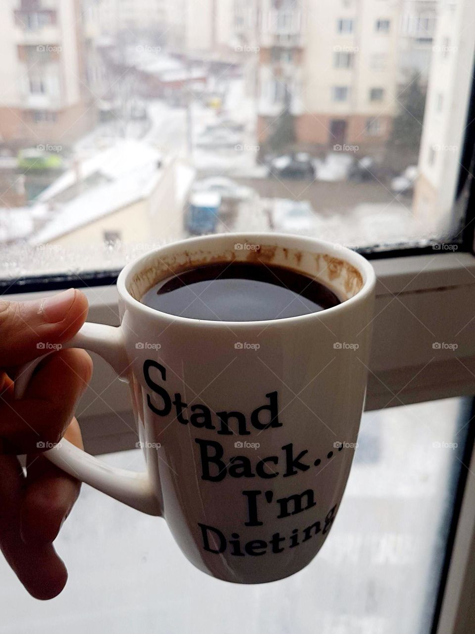 big cup of coffee in the morning by the window