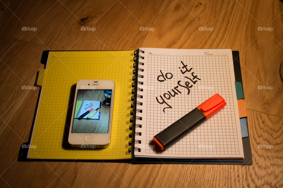 Motivational letter in a notebook on the desktop under the light of a lamp