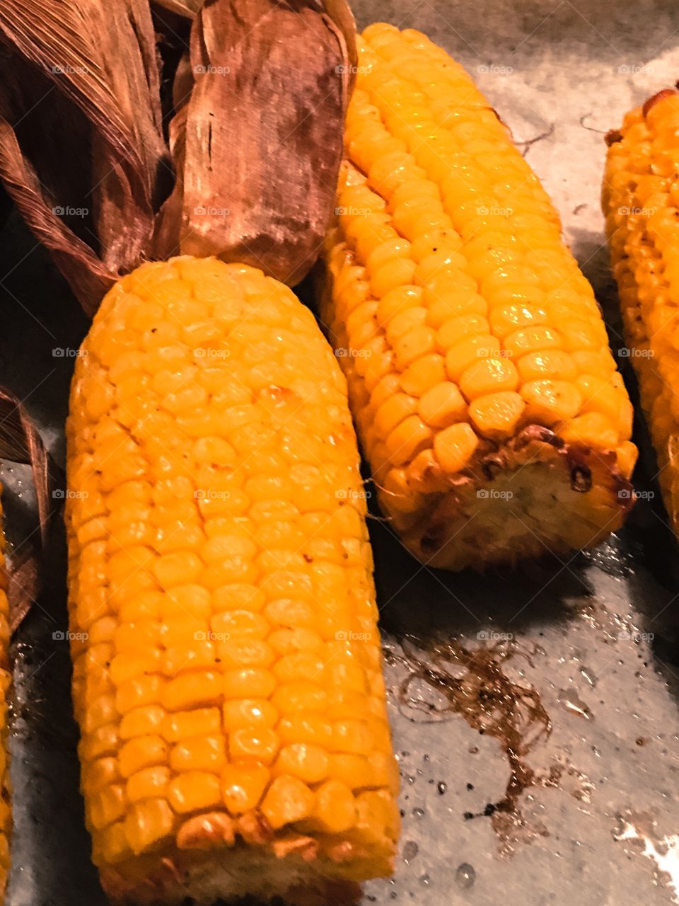 Close up background view corn on the carb with husks buttery yellow delicious