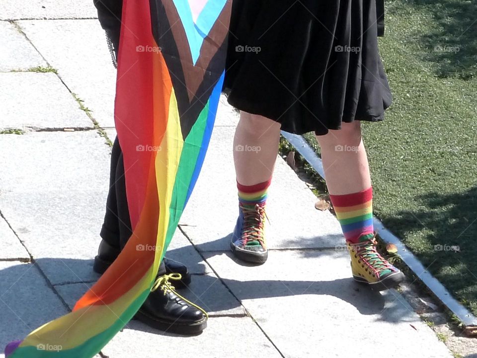 a pair of socks and a flag in the colors of the LGBTQ+ community to express pride in belonging to it