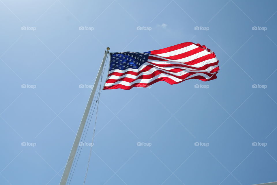 Flying Proud. Flag flying over the Arizona memorial in Pearl Harbor