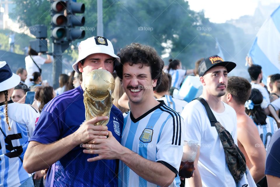 Buenos-Aires - 18.12.2022: Football fans of national team of Argentina in t-shirts on national team celebrating victory on the streets