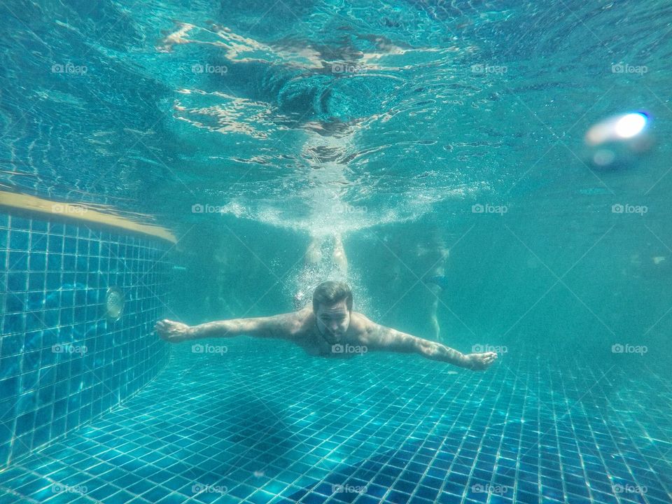 Underwater man in swimming pool