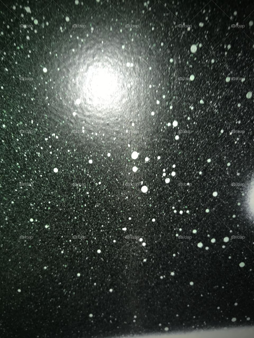 Up close photo of aerosol canvas art of stars and space 