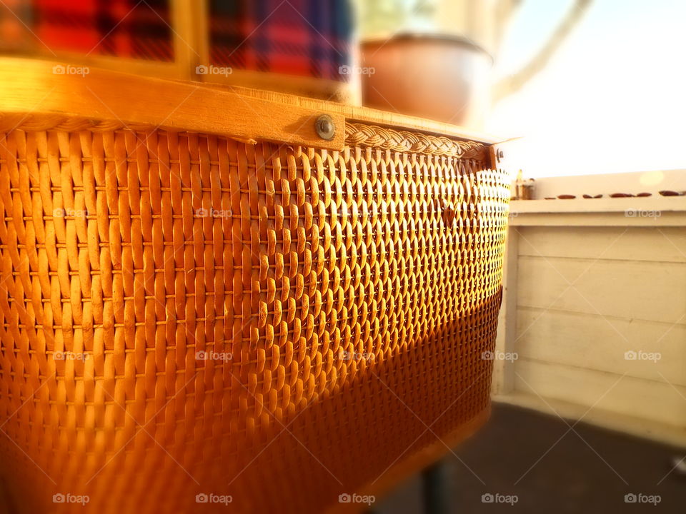 Closeup of old wicker picnic basket In sunlight
