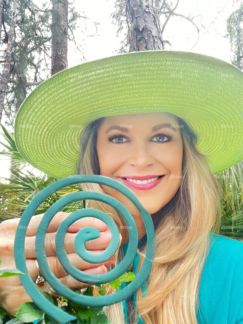 Woman in a yellow hat displaying a product.