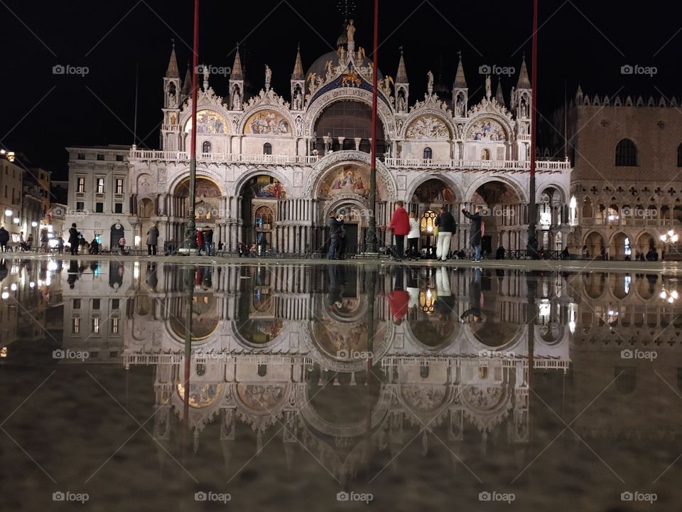 Venice and one of it's most recognizable and breathtaking symbols, San Marcos's cathedral. Outstanding above the dimness of the night, the reflection showing how material objects are inherented in art.