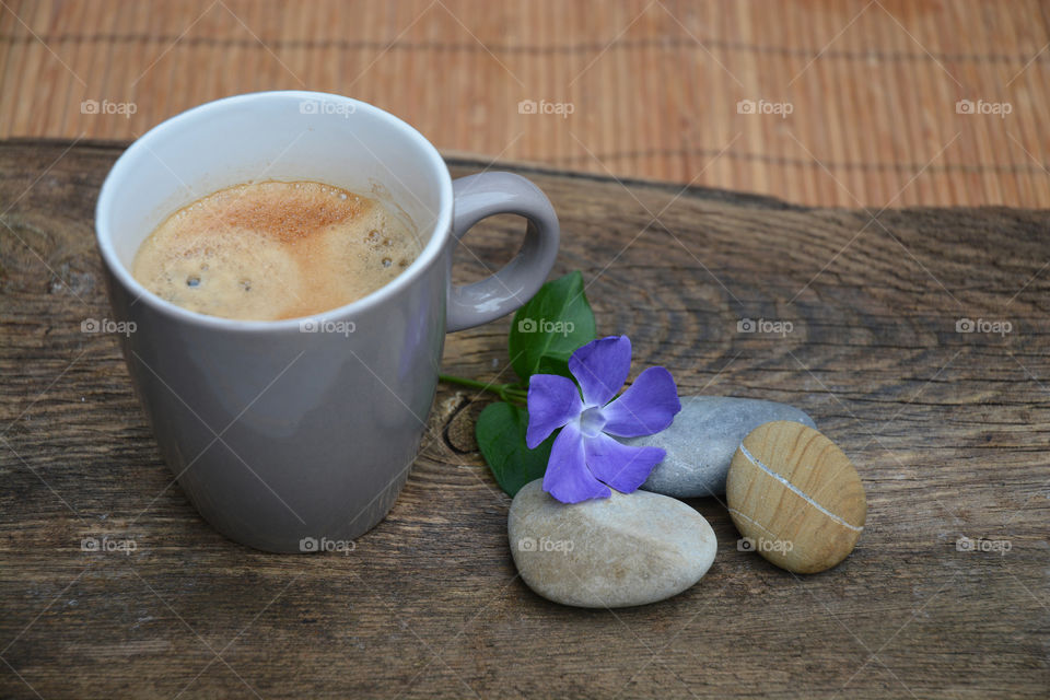 cup of coffee on a wooden background with zen cairn stones