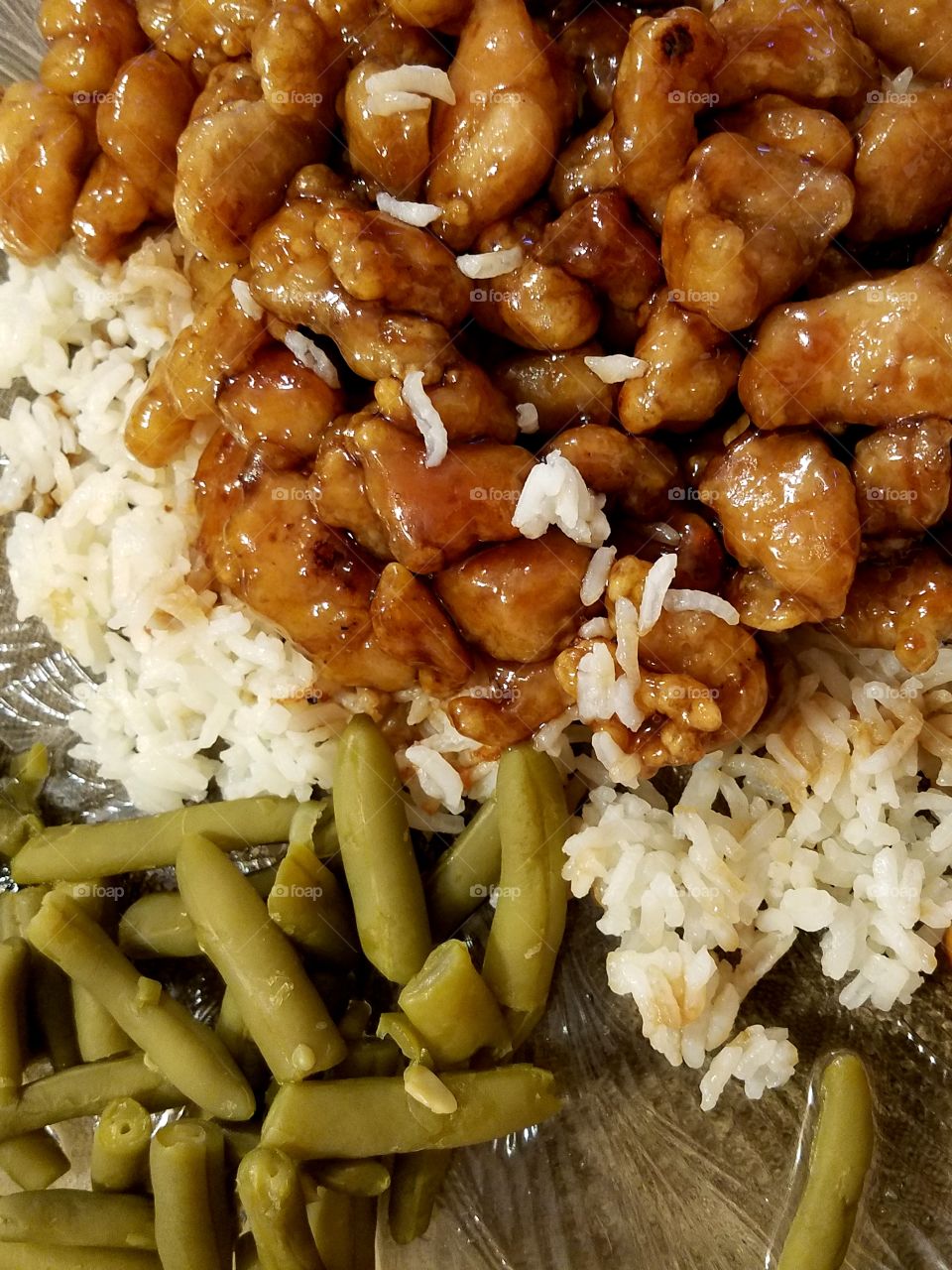 Orange chicken on white rice with green beans