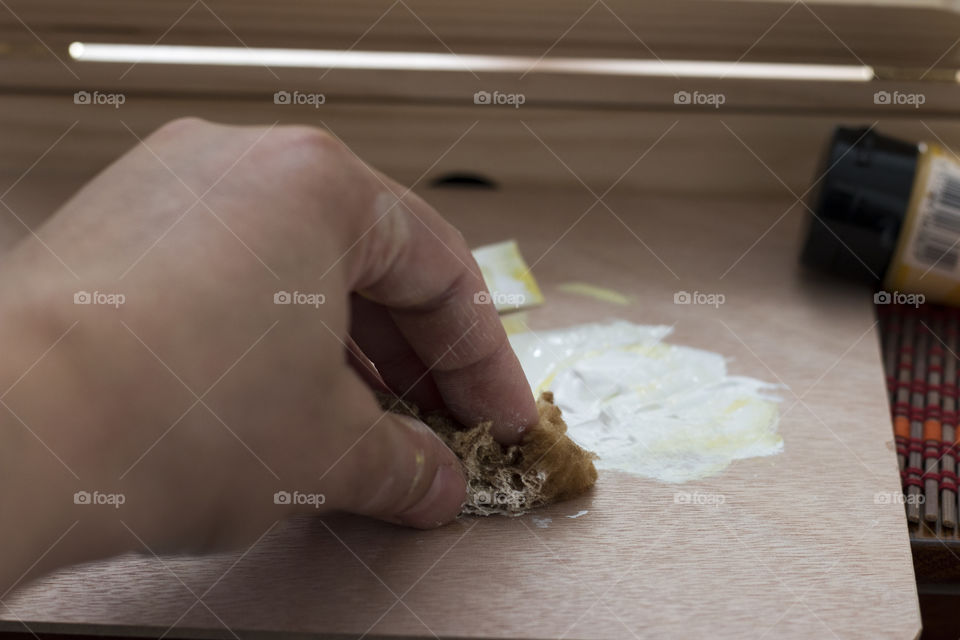 A person cleaning stained on table