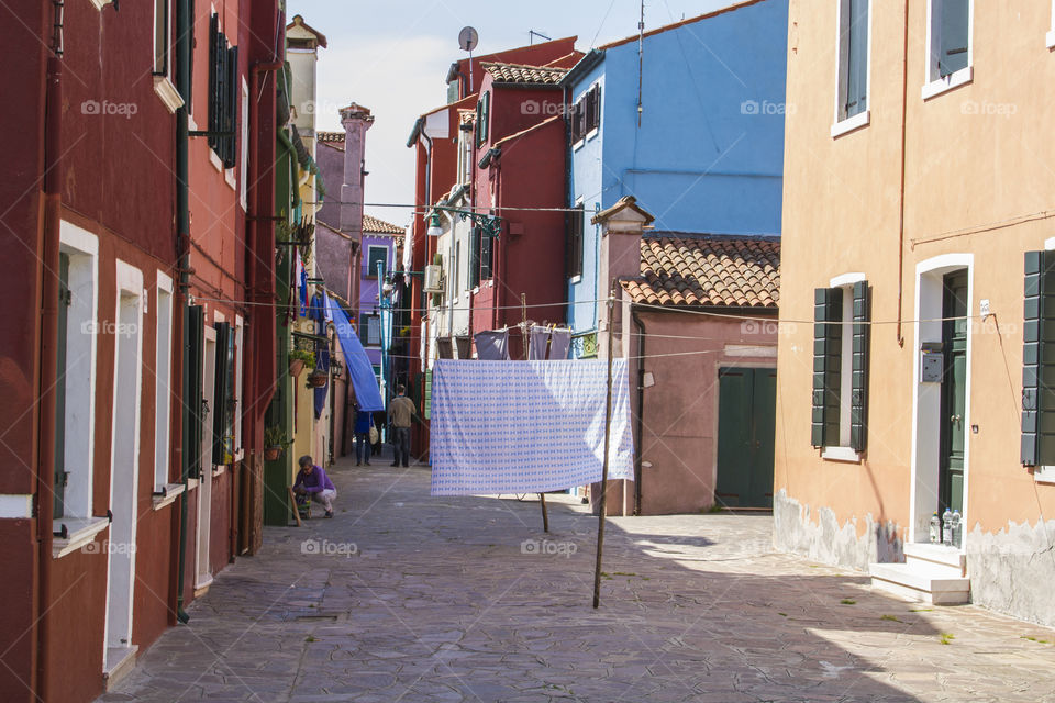 Laundry drying outside in a street in Burano, Italy. 