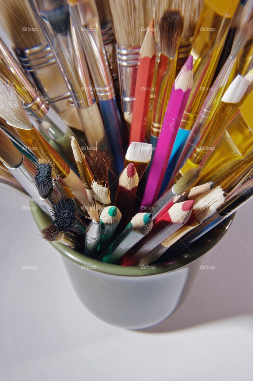 Cup of art supplies. Paint brushes, color pencils, etc. artistic