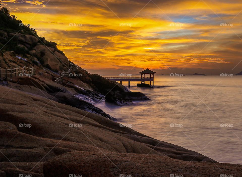 Beautiful Scene at Break of Dawn at the rocky beach area