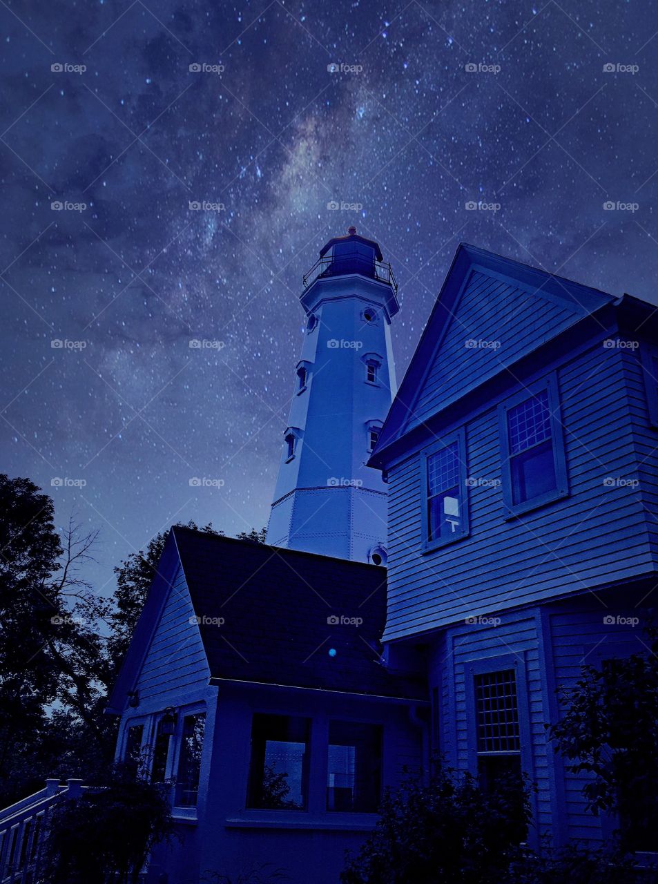 View of a house and lighthouse at night