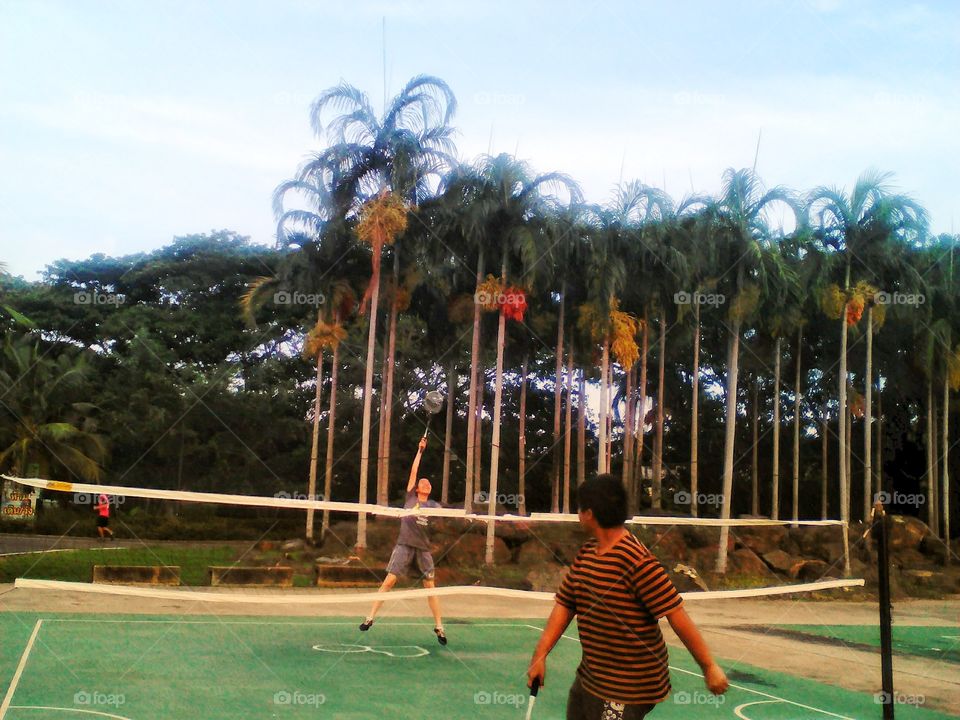 Playing badminton in the park.