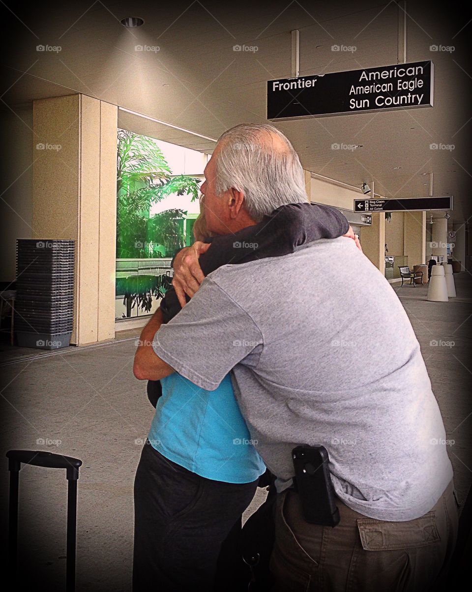 A long awaited loving embrace between a Mother and her Son at the airport.