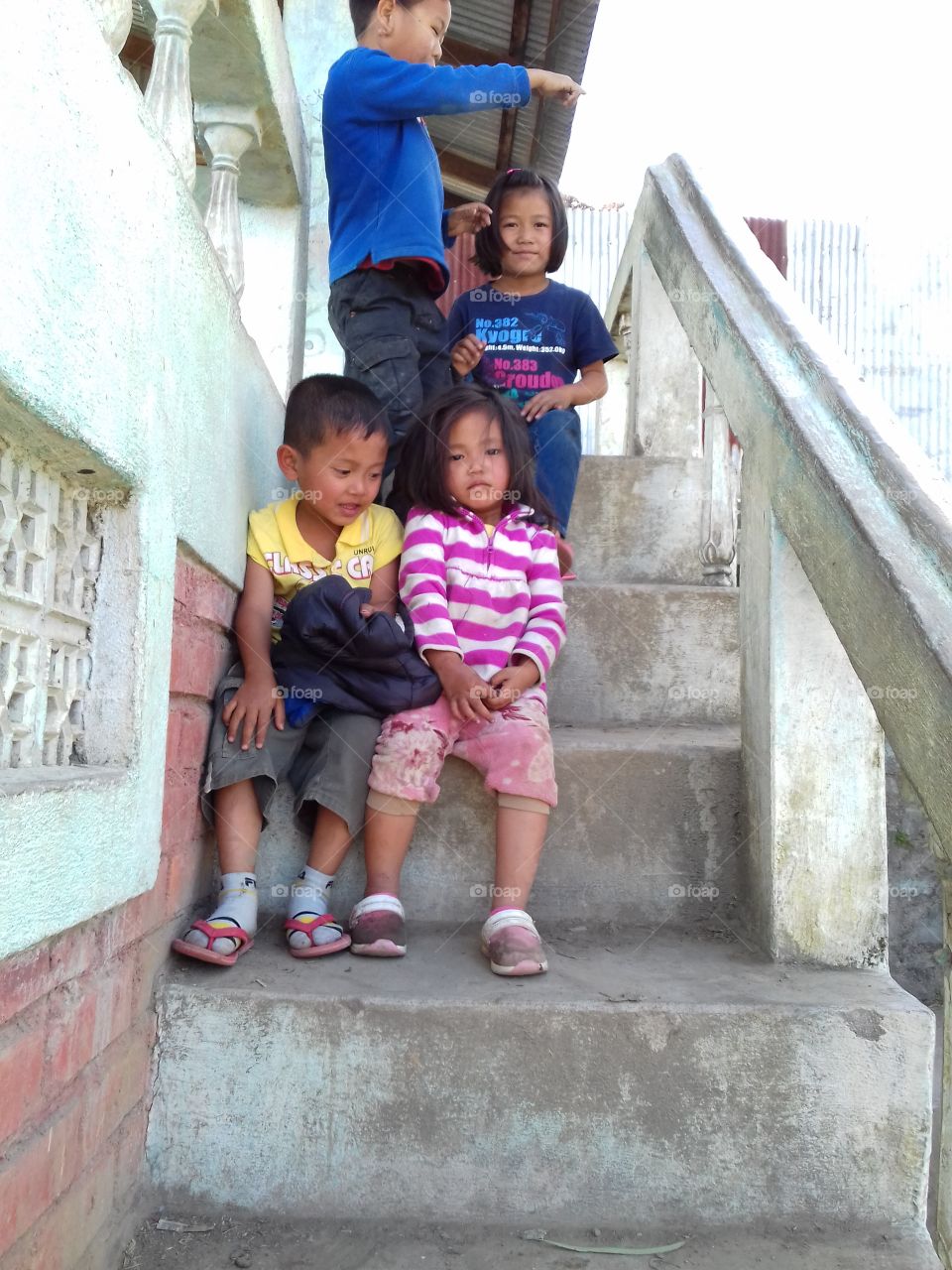children pose at the stair