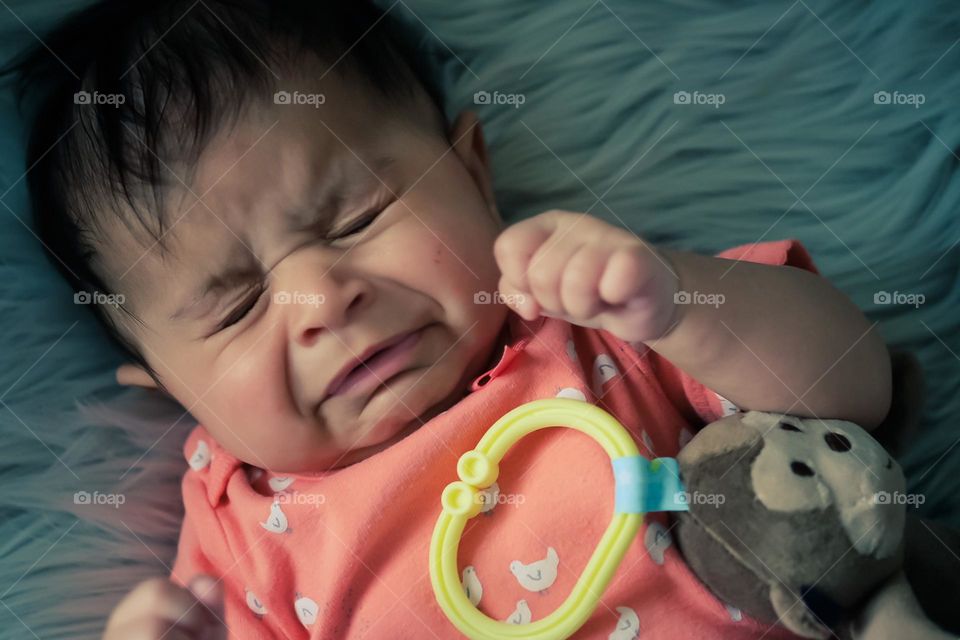 Baby girl crying because she is sad, baby crying, baby expressing emotions of sadness, baby is sad and crying, facial expressions on infants 