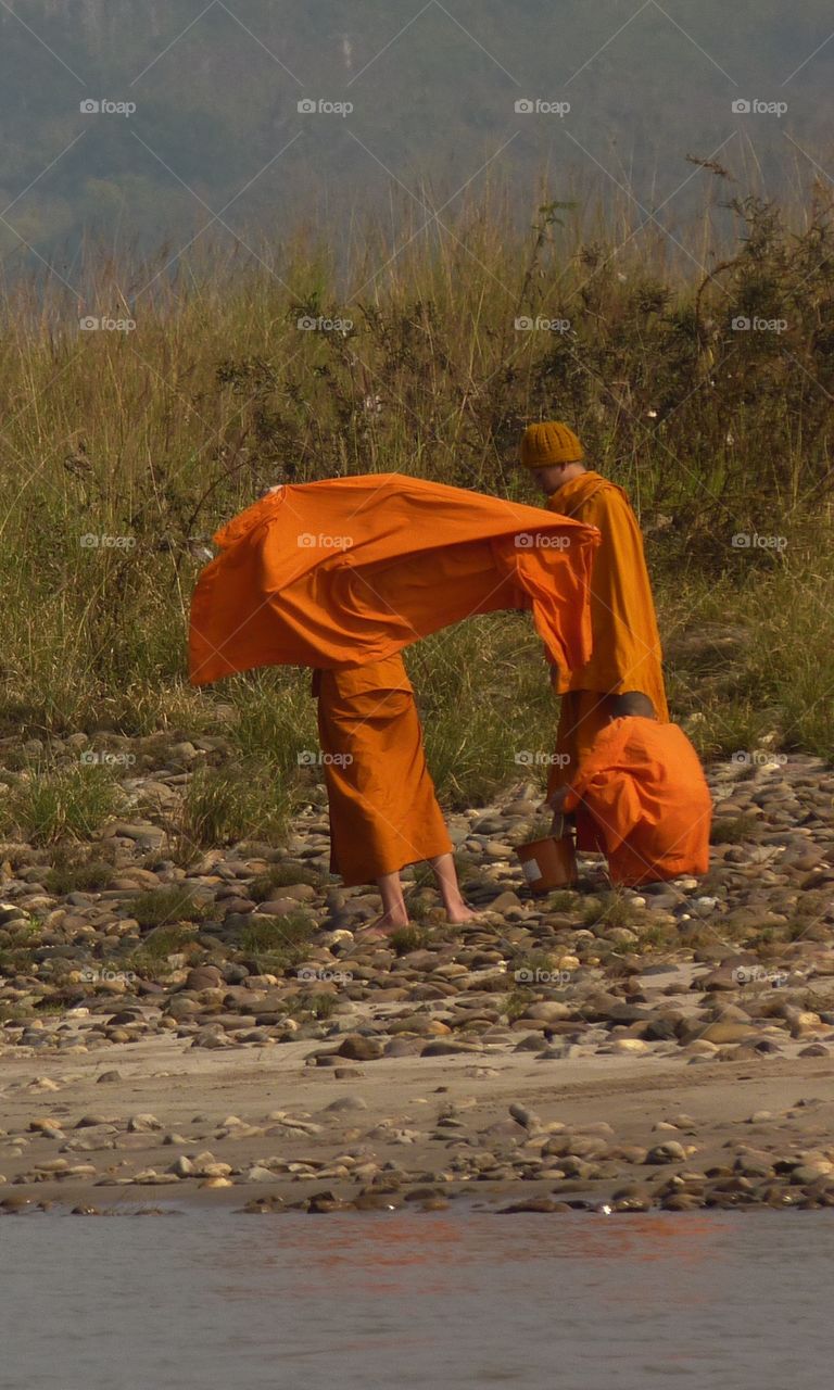 Monks gathering stone on the Mekong