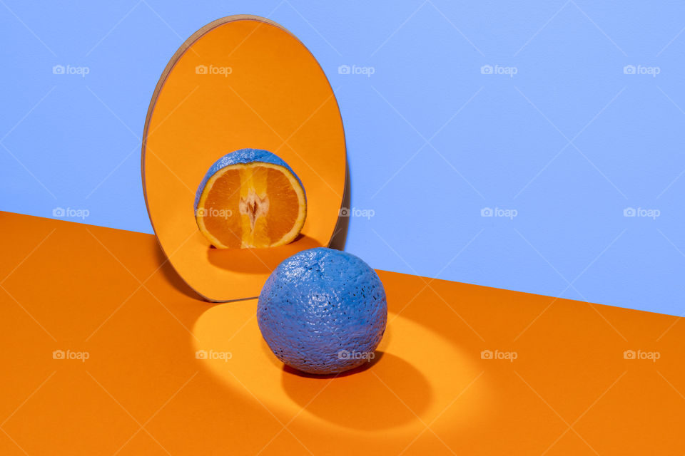 Blue orange on orange background on a mirror.