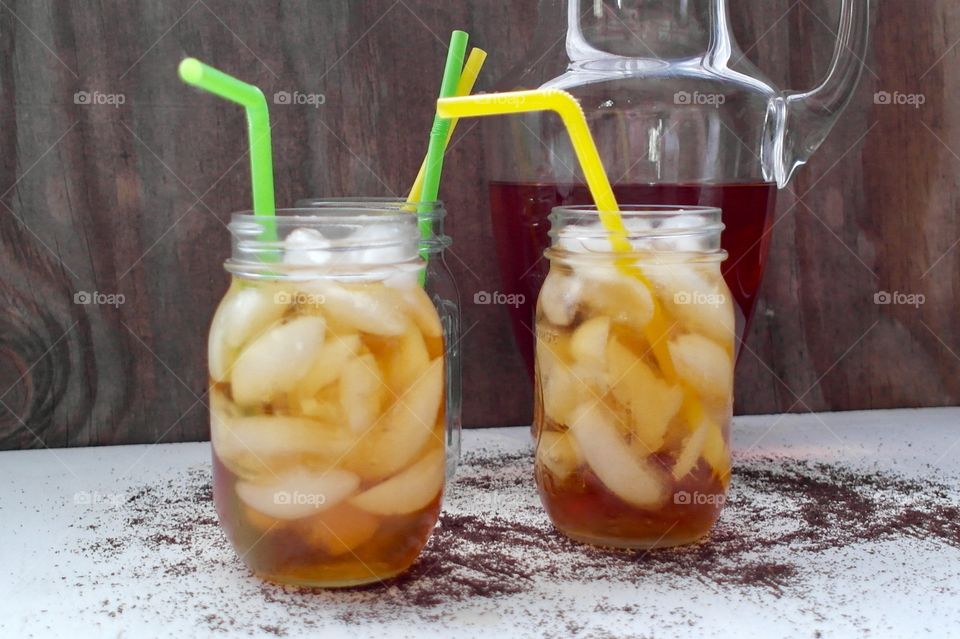Close-up of ice tea with straw in jar